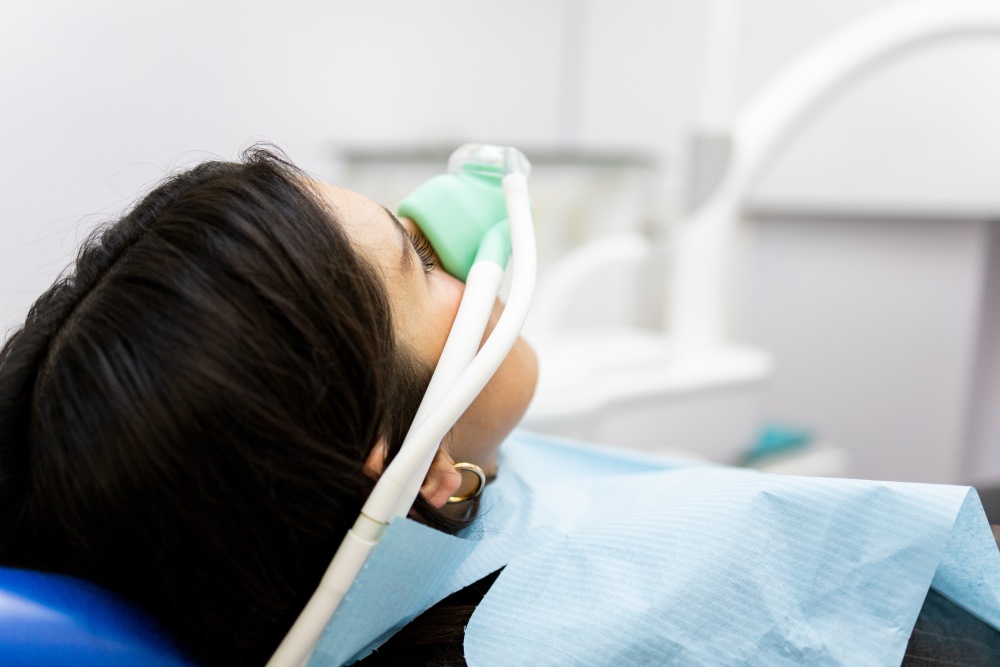 A woman receiving nitrous oxide before a dental procedure.