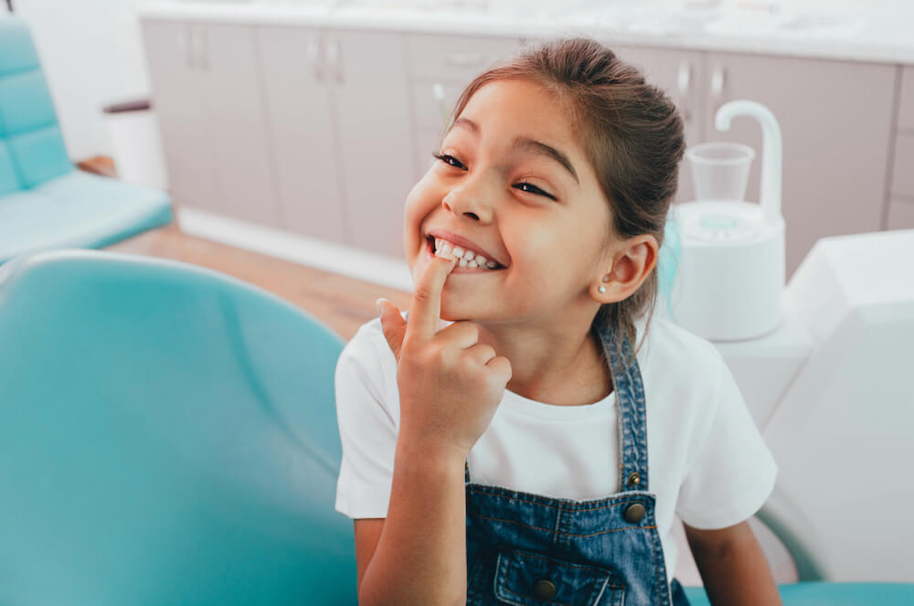 little girl at the dentist after a great visit from keeping her teeth clean
