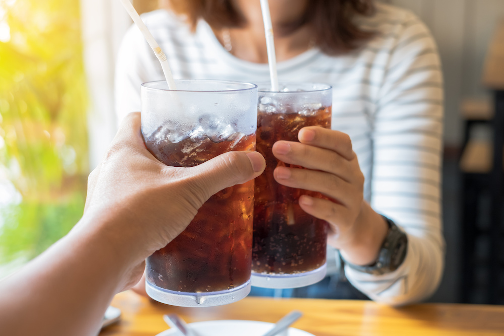 woman and man drinking soda, which is bad for your teeth