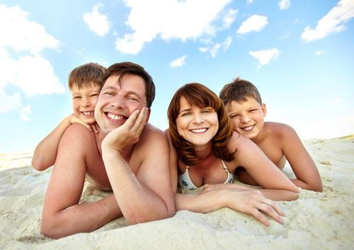 Family smiling in a beach