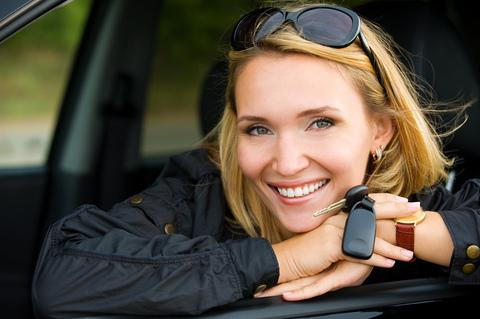 Woman inside a car holding car keys
