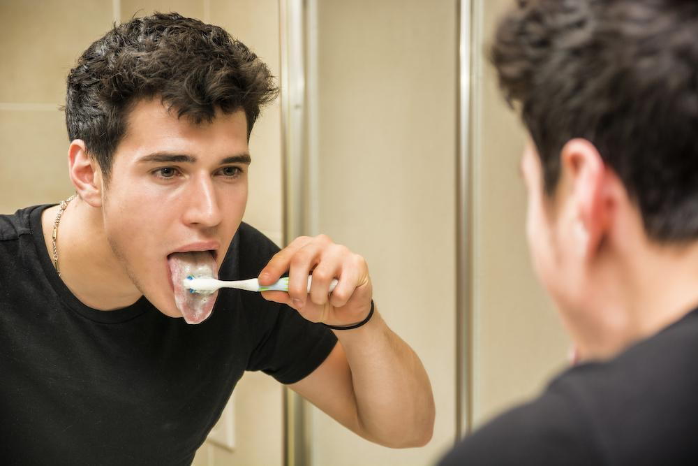 Man brushing tongue